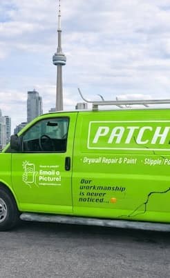 Drywall repair truck in front of CN tower in toronto