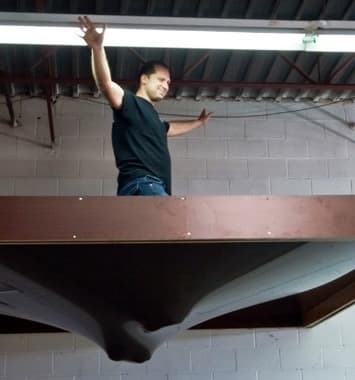 PatchBoyz demonstrates the tensile strength of PVC stretch ceiling membrane by standing on it from above whilst the ceiling is in a suspended frame.