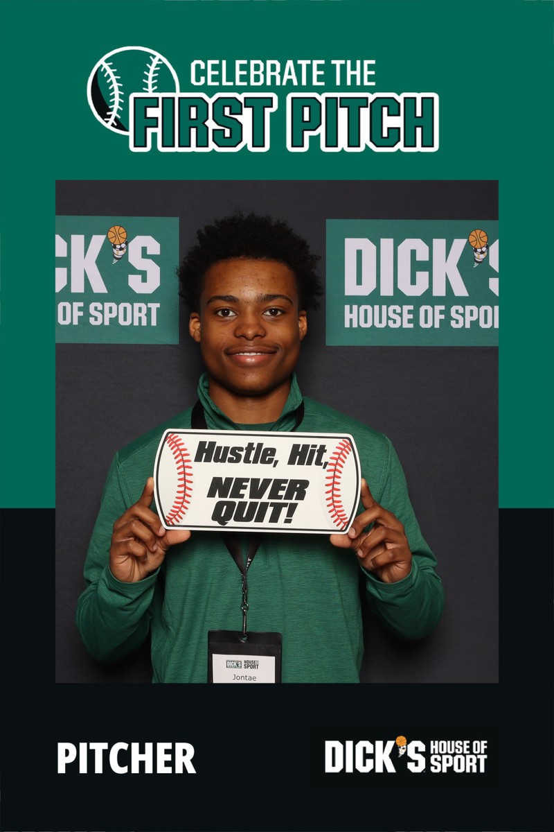 A guest posing in a photo booth at a Dick’s House of Sport “Celebrate the First Pitch” event, holding a baseball-themed sign in front of a branded sports backdrop, captured in a professional photo booth setup.