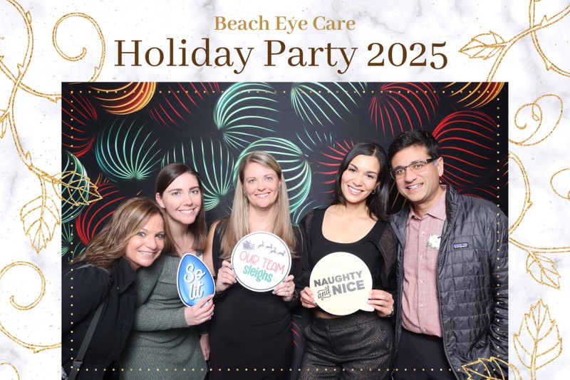 A group of five guests smiling and posing at the Beach Eye Care Holiday Party 2025 in front of a colorful holiday photo booth backdrop, holding festive holiday props during a corporate celebration.