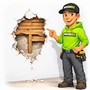 a hole in a plaster wall that is revealing the wood lath in behind. Technician standing beside