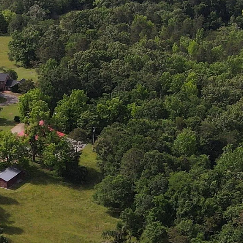 Aerial view showing the beautiful 4-acre stocked lake, perfect for fishing, reflection, and family activities