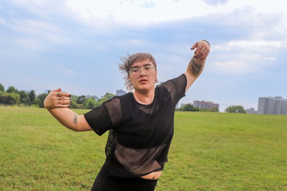 Three dancers move in motion in the sky room at Loyola Park.