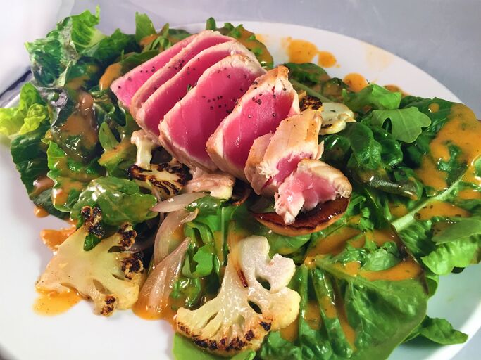 sauteed cauliflower, spring onions, grilled peaches, baby romaine lettuce and arugula with honey vinaigrette‍‍‍. EastBurn Public House. Portland