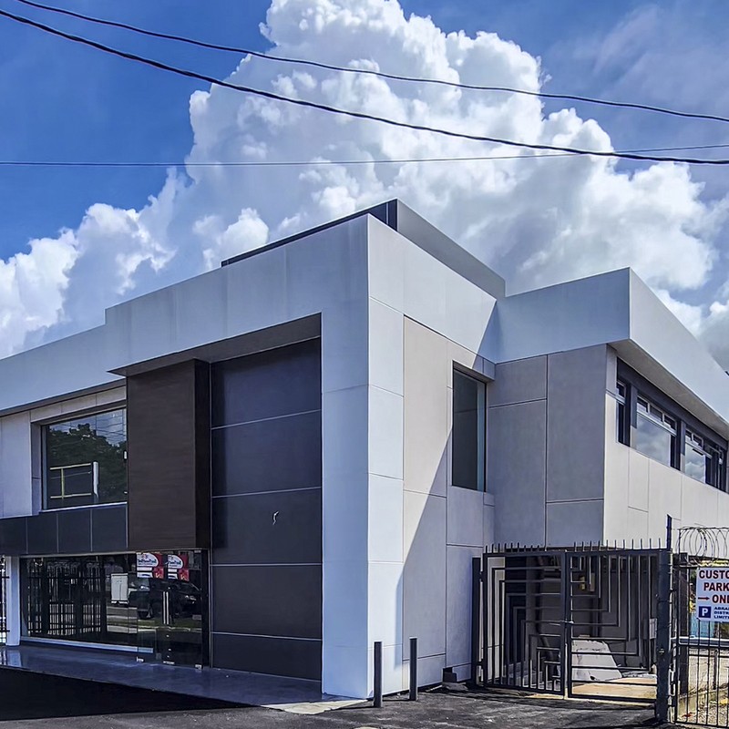 Oblique angle shot showing the newly installed facade of a building, coloured in brown and grey.