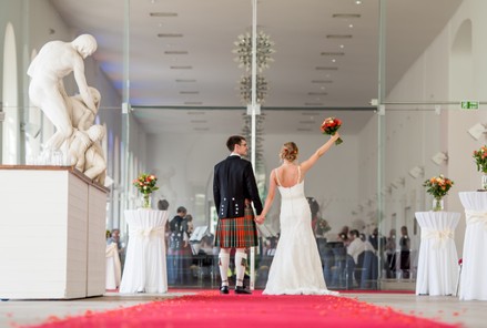 Bride and groom photographed at The Orangery in Margam Park, Port Talbot, South Wales. The glass-fronted Orangery and surrounding formal gardens provide natural light and elegant backdrops, creating timeless and cinematic wedding photography.
