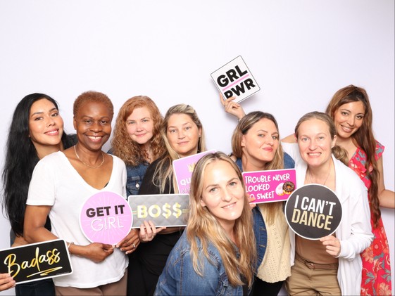 Wedding guests at white backdrop photo booth in Hampton Roads