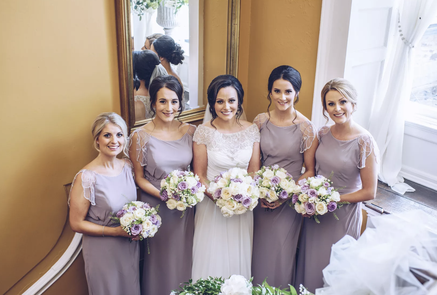 Bridesmaids and bride photographed on the stairs at Peterstone court South Wales