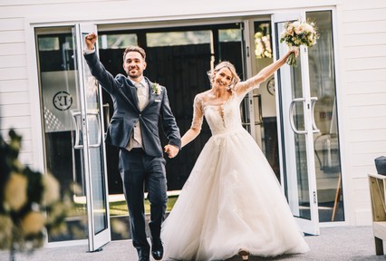 Entrance shot of a bride and groom at Llanerch vineyard, a South Wales wedding venue.