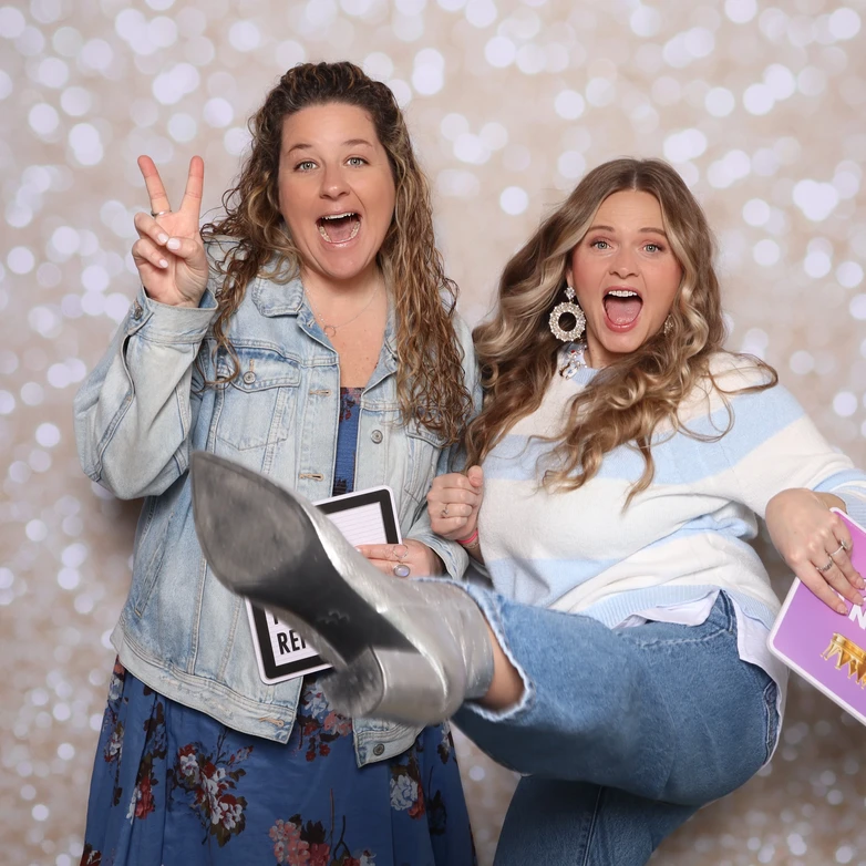 Guests laughing and posing during a baby shower photo booth moment in Hampton Roads