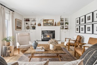 Beautiful living room with stone fireplace and floor to ceiling windows