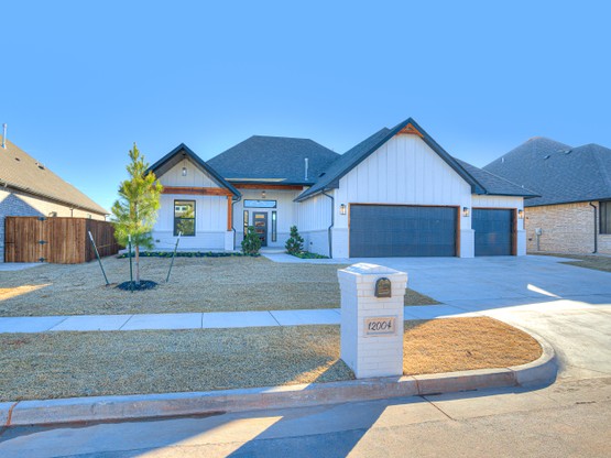 A single-story custom home built by Merryfield Homes in Mustang Ridge, Oklahoma. The Adkinson Home features a brick exterior, large windows, and an inviting entryway that reflects Merryfield’s signature craftsmanship and attention to detail.