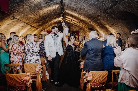 Bride and groom walking back up the aisle at a wedding ceremony at Cardiff castle