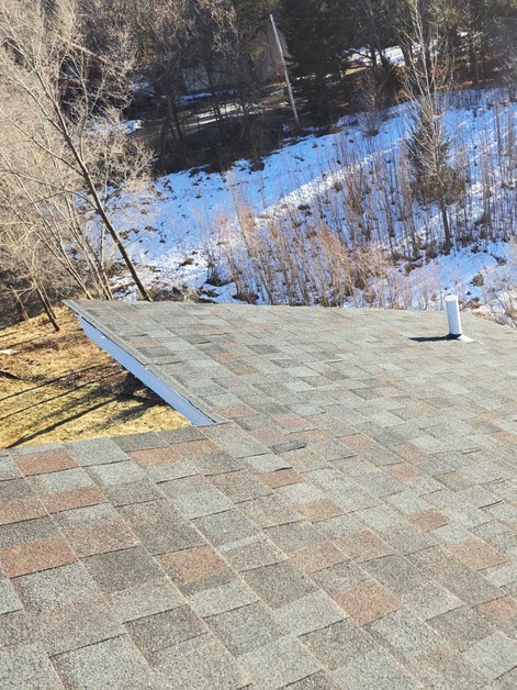 Home elevator outside roof with shingles.