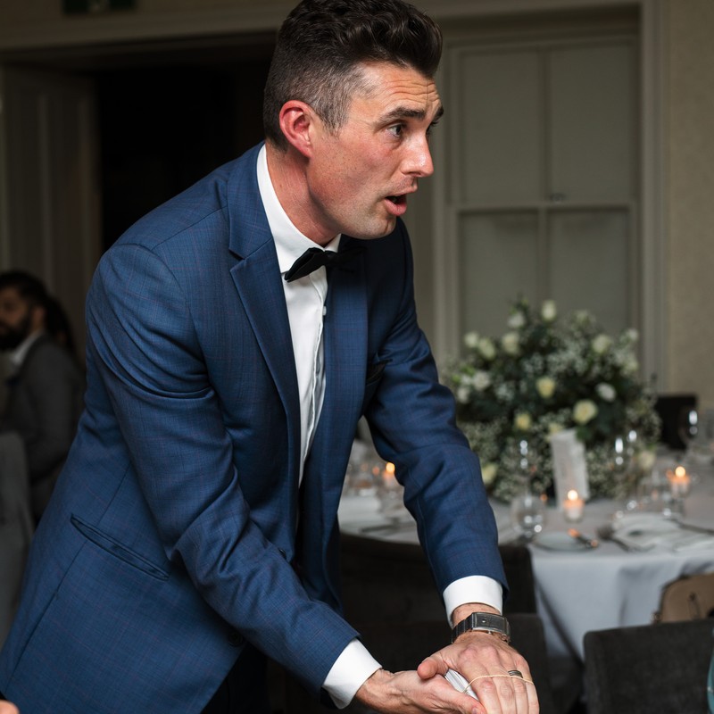 Sydney magician Alex Moffat performing magic on stage at a corporate event