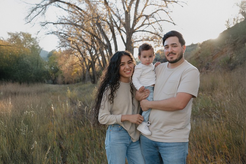 Picture of Angie Larsen standing next to a large cutout of 13.1 at her half-marathon registration day