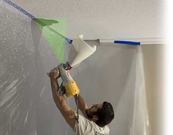 Jud spraying stipple onto a ceiling creating a hard line between the kitchen and Dining room, Creating a perfect Popcorn ceiling repair.