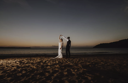 A bride and groom dance at sunset on the beach at Oxwich bay Gower, south wales coastal wedding venue in Swansea