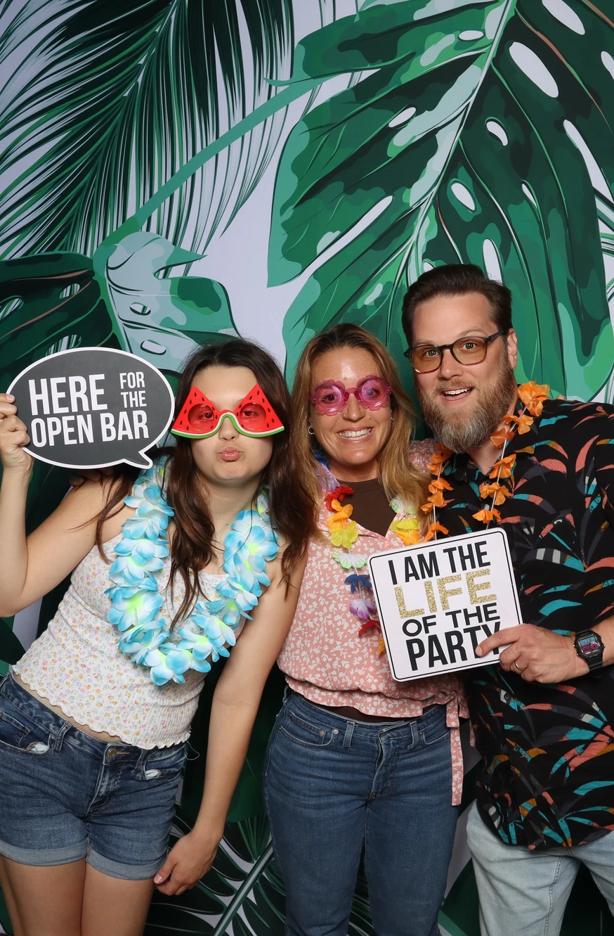 Family posing with fun photo booth props at a Chesapeake celebration