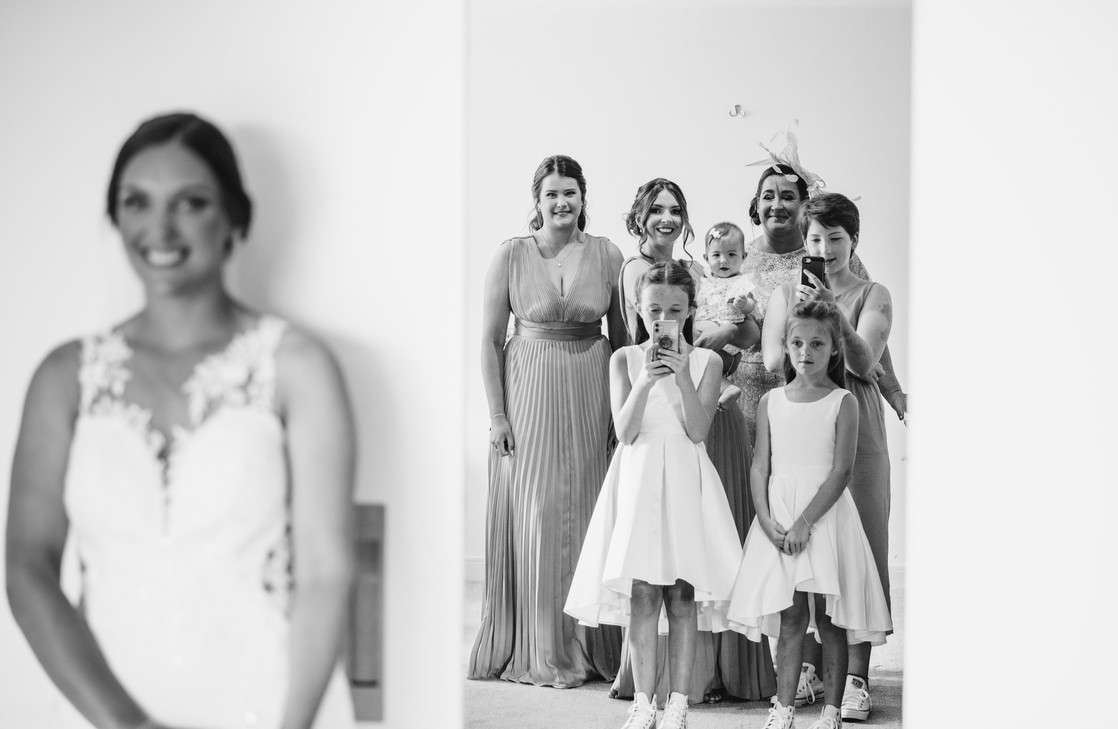 bride with bridesmaids on the morning of the her wedding during bridal prep. Wedding photography by South Wales wedding photographer Karl Baker