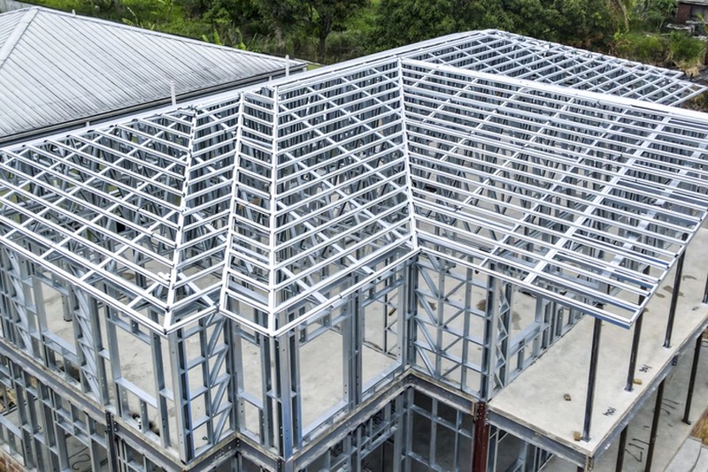 Aerial shot of a job site showing the steel-frame structure of a house renovation in progress.