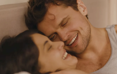Close up of a woman's face smiling and a man's face smiling