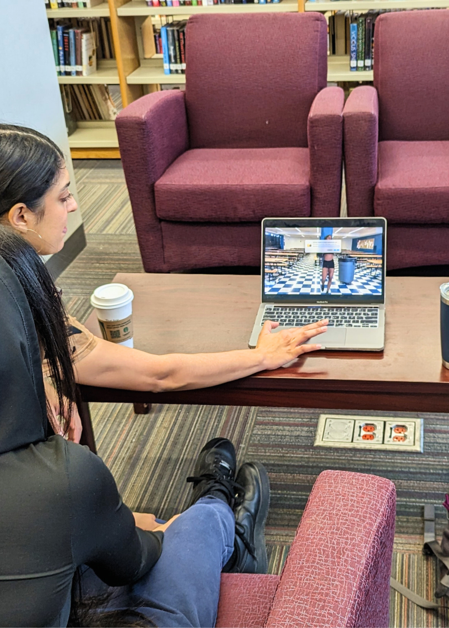 Amanda guides a student in the video editing of a dance film.